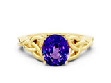Yellow gold Oval Cut Tanzanite Solitaire Engagement Ring with Celtic Knot Band and Four-Prong Setting