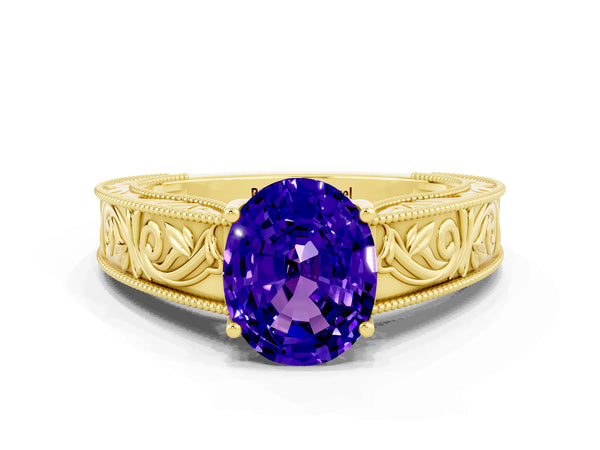 Yellow gold Oval Cut Tanzanite Solitaire Ring with Engraved Band and Four-Prong Setting