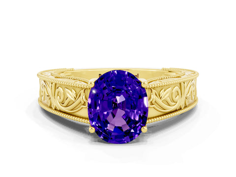 Yellow gold Oval Cut Tanzanite Solitaire Ring with Engraved Band and Four-Prong Setting