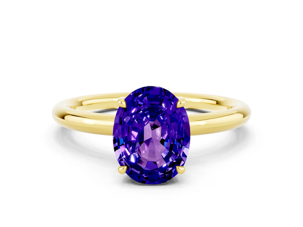 Yellow gold Oval Cut Tanzanite Solitaire Ring with Thin Band and Four-Prong Setting
