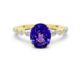 Yellow gold Oval Cut Tanzanite Solitaire with Side Stones on a Pavé Band and Four-Prong Setting