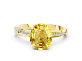 Yellow gold Oval Cut Yellow Sapphire Engagement Ring with Side Stone Accents and Four-Prong Setting_60