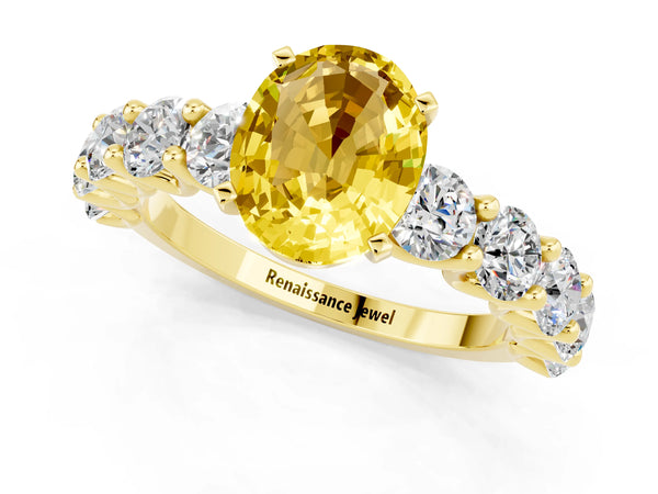 Yellow gold Oval Cut Yellow Sapphire Prong Setting with Side Stones on a Pave Band