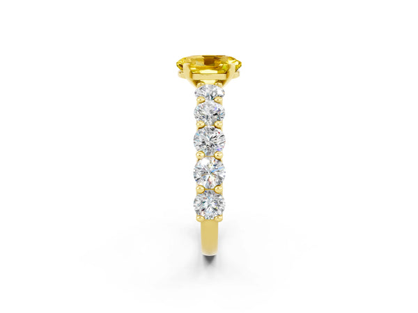 Yellow gold Oval Cut Yellow Sapphire Prong Setting with Side Stones on a Pave Band