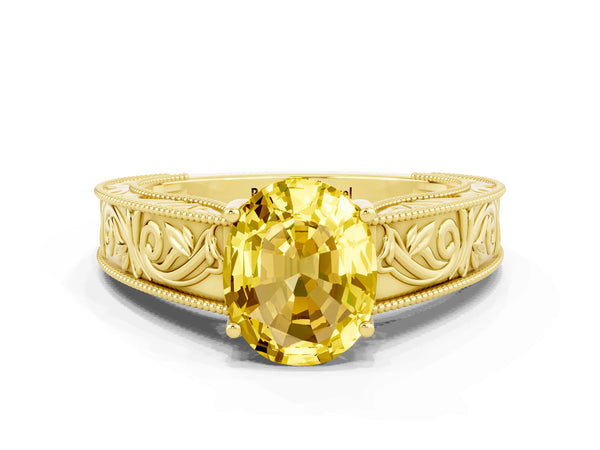 Yellow gold Oval Cut Yellow Sapphire Solitaire Ring with Engraved Band and Four-Prong Setting
