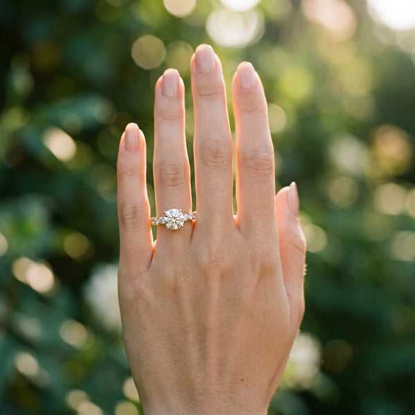 Yellow gold Oval Diamond Solitaire Ring with Shared Prong Round Side Stones