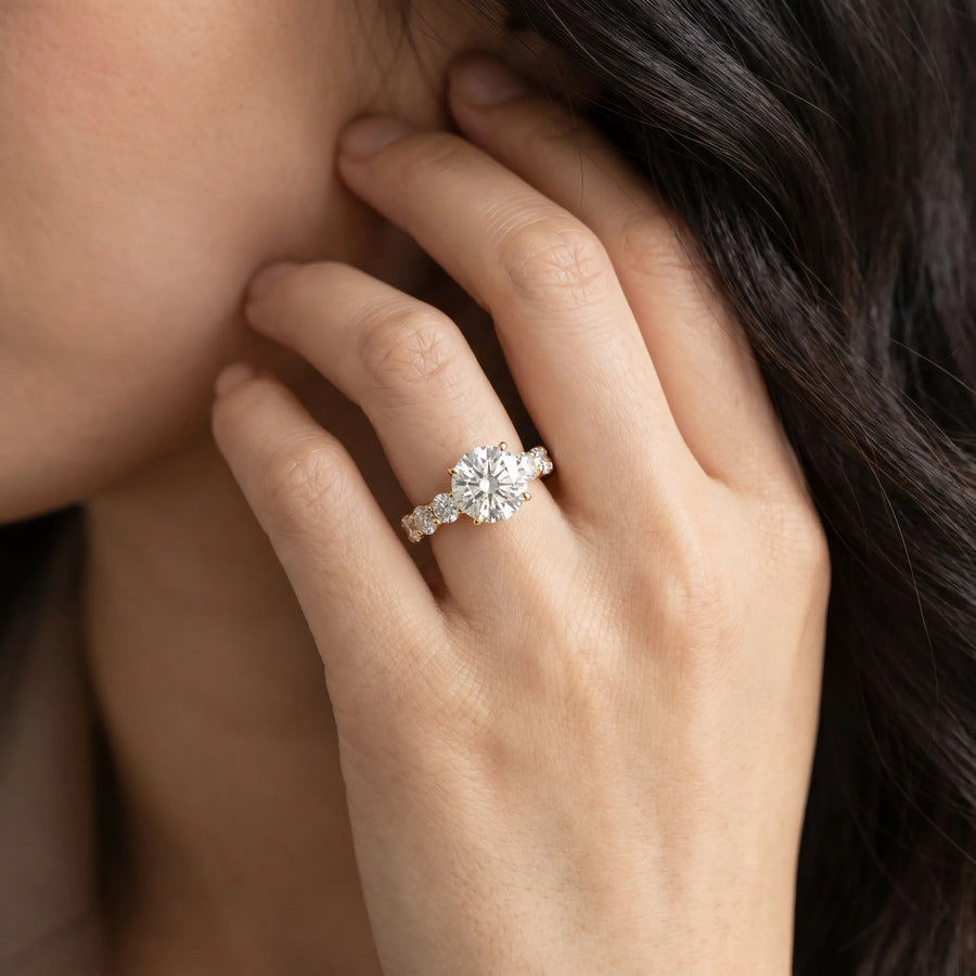 Yellow gold Oval Diamond Solitaire Ring with Shared Prong Round Side Stones