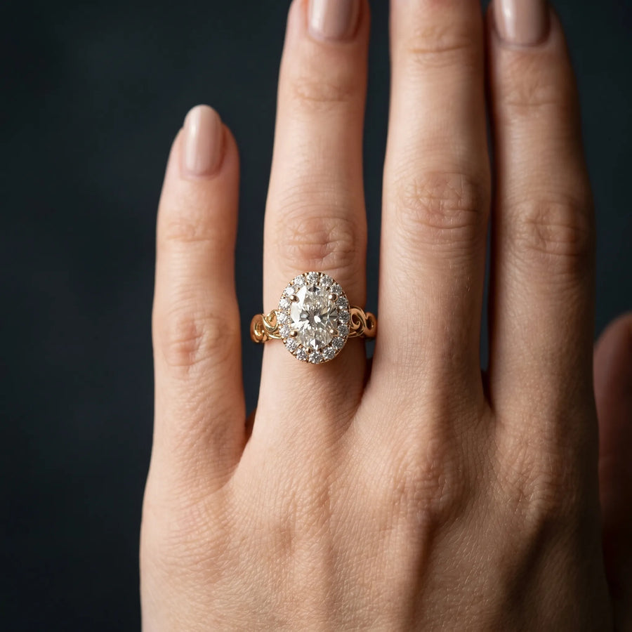 Yellow gold Oval Halo Diamond Ring with Scrollwork Band and Four-Prong Setting