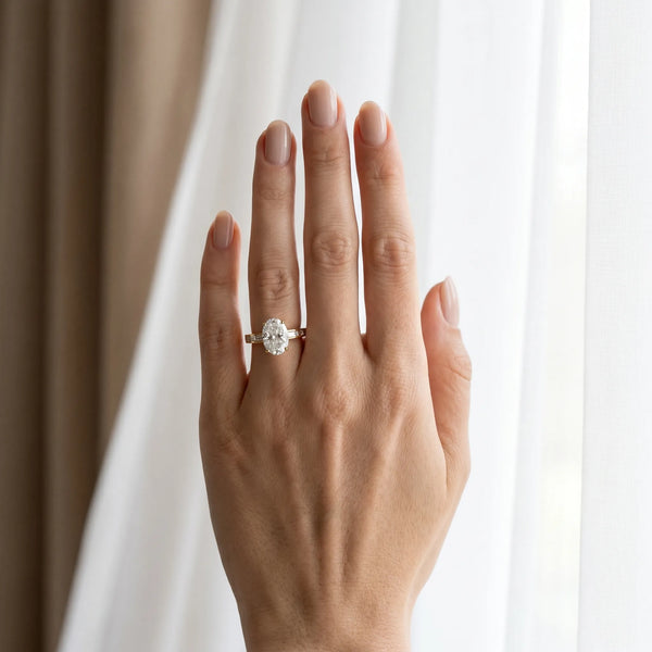 Yellow gold Oval Solitaire Diamond Ring with Channel-Set Baguette Band and Four-Prong Setting