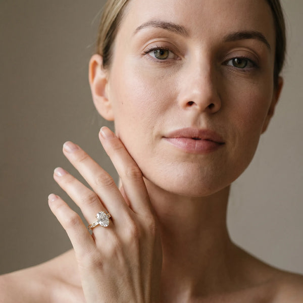 Yellow gold Oval Solitaire Diamond Ring with Channel-Set Baguette Band and Four-Prong Setting