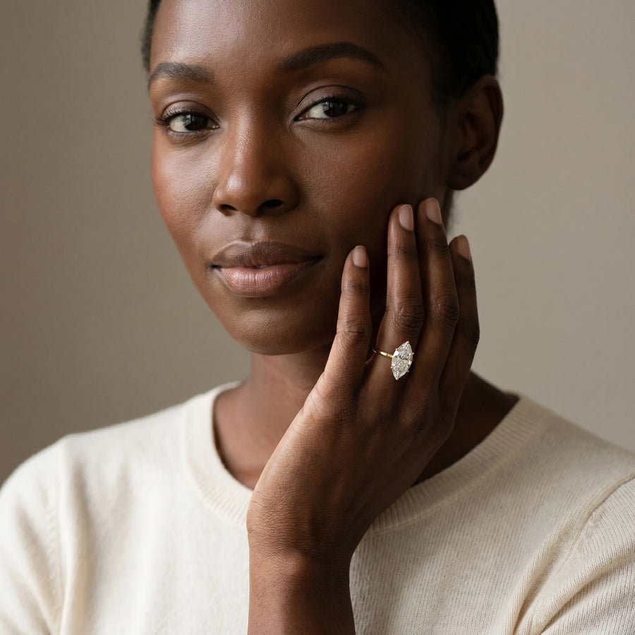 Yellow gold Oval Solitaire Diamond Ring with Four-Prong Setting on a Plain Band