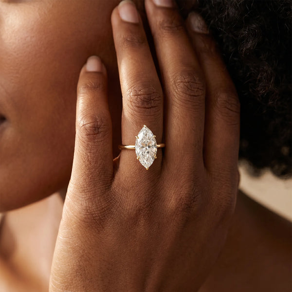 Yellow gold Oval Solitaire Diamond Ring with Four-Prong Setting on a Plain Band