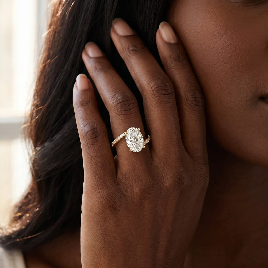 Yellow gold Oval Solitaire Twist Band with Pave Set Diamonds and Four-Prong Setting