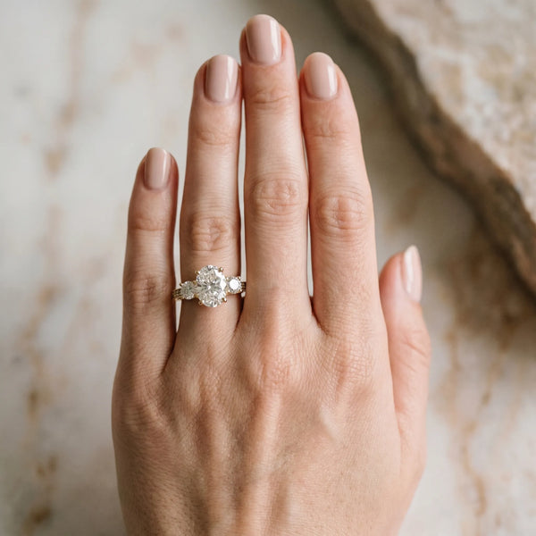 Yellow gold Oval Three-Stone Diamond Ring with Pavé Band and Four-Prong Setting