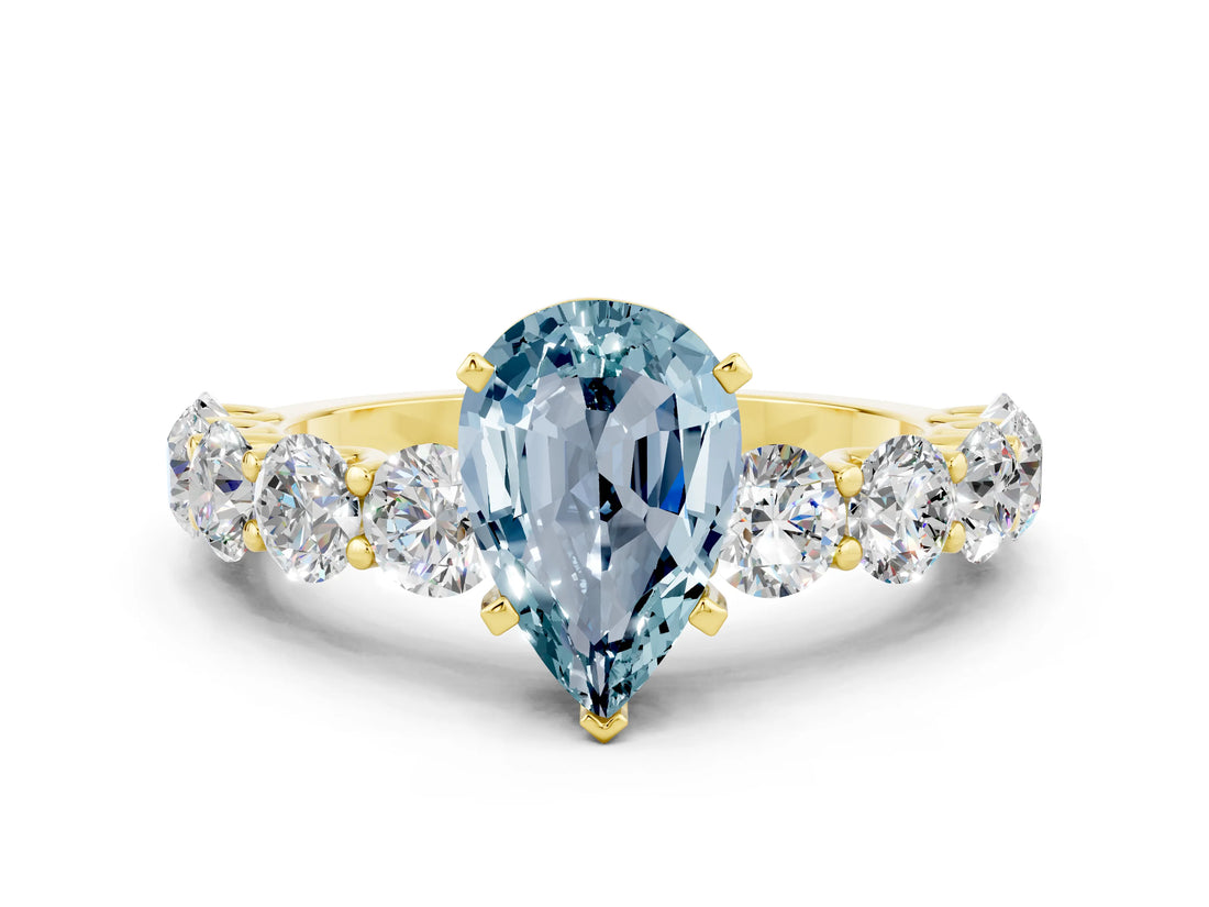Yellow gold Pear Cut Aquamarine Prong Setting with Side Stones on a Pave Band