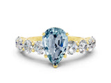 Yellow gold Pear Cut Aquamarine Prong Setting with Side Stones on a Pave Band