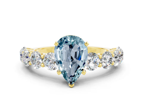 Yellow gold Pear Cut Aquamarine Prong Setting with Side Stones on a Pave Band