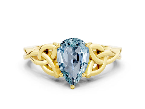 Yellow gold Pear Cut Aquamarine Solitaire Engagement Ring with Celtic Knot Band and Four-Prong Setting