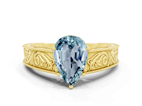 Yellow gold Pear Cut Aquamarine Solitaire Ring with Engraved Band and Four-Prong Setting