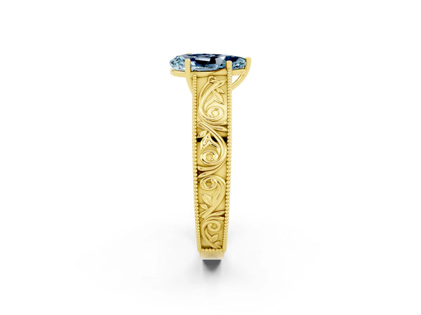Yellow gold Pear Cut Aquamarine Solitaire Ring with Engraved Band and Four-Prong Setting