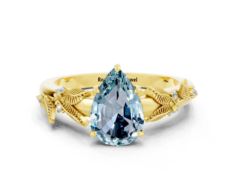 Yellow gold Pear Cut Aquamarine Solitaire Ring with Leaf Motif Band and Four-Prong Setting