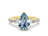 Yellow gold Pear Cut Aquamarine Solitaire with Side Baguettes and Channel Set Band