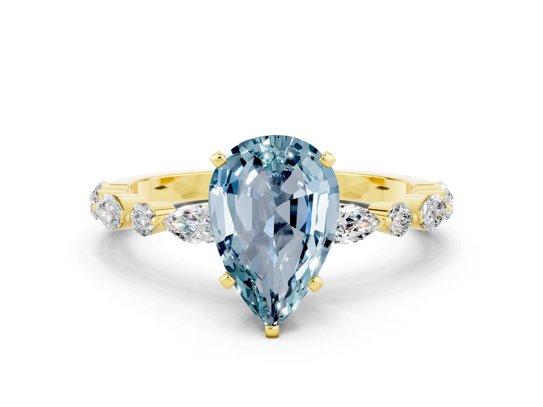 Yellow gold Pear Cut Aquamarine Solitaire with Side Stones on a Pavé Band and Four-Prong Setting