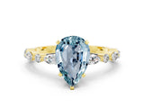 Yellow gold Pear Cut Aquamarine Solitaire with Side Stones on a Pavé Band and Four-Prong Setting