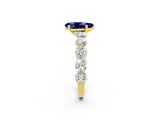Yellow gold Pear Cut Blue Sapphire Prong Setting with Side Stones on a Pave Band_2