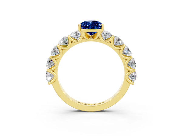 Yellow gold Pear Cut Blue Sapphire Prong Setting with Side Stones on a Pave Band