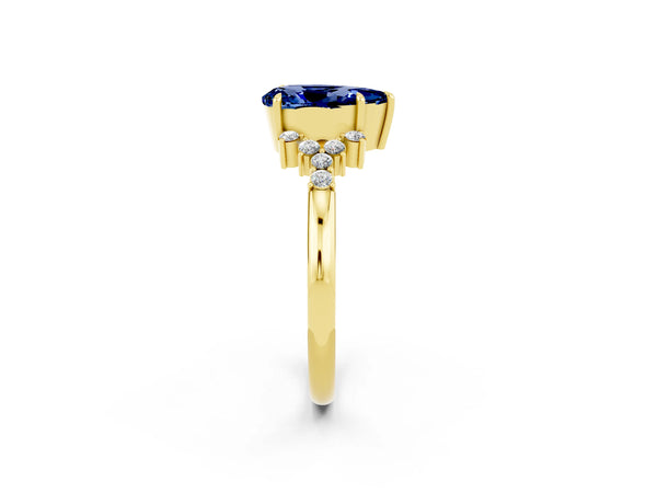 Yellow gold Pear Cut Blue Sapphire Ring with Side Stones and Four-Prong Setting