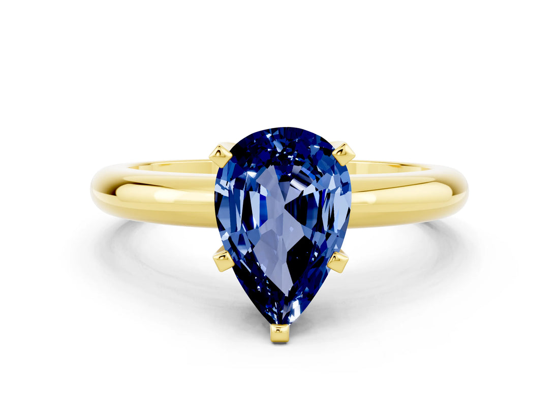 Yellow gold Pear Cut Blue Sapphire Solitaire Engagement Ring with Round Band and Four-Prong Setting
