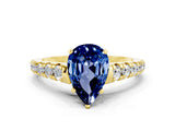 Yellow gold Pear Cut Blue Sapphire Solitaire Ring with Cathedral Setting and Pavé Band