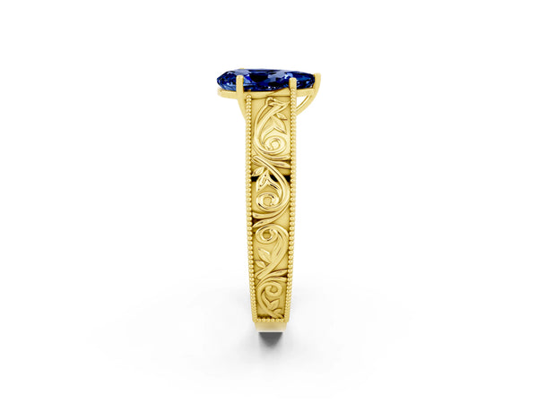 Yellow gold Pear Cut Blue Sapphire Solitaire Ring with Engraved Band and Four-Prong Setting
