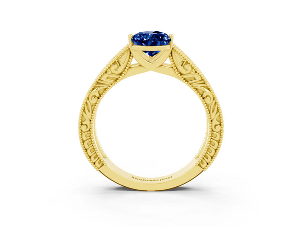 Yellow gold Pear Cut Blue Sapphire Solitaire Ring with Engraved Band and Four-Prong Setting