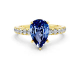 Yellow gold Pear Cut Blue Sapphire Solitaire Ring with Pavé Accents and Four-Prong Setting