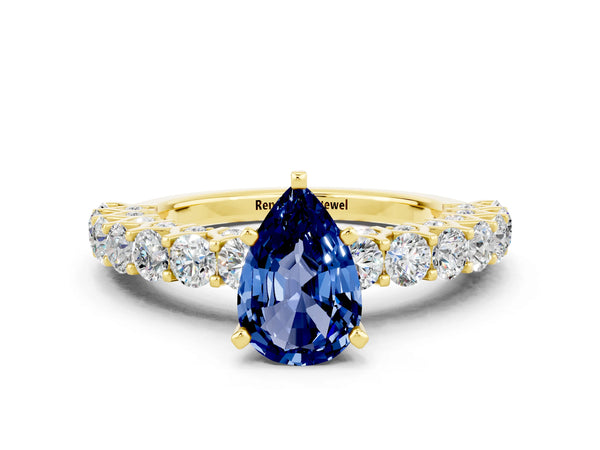 Yellow gold Pear Cut Blue Sapphire Solitaire Ring with Shared Prong Pavé Band and Four-Prong Setting