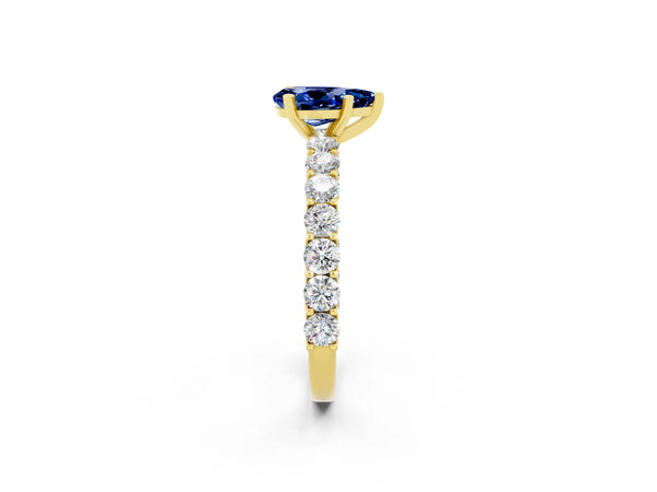 Yellow gold Pear Cut Blue Sapphire Solitaire Ring with Shared Prong Pavé Band and Four-Prong Setting
