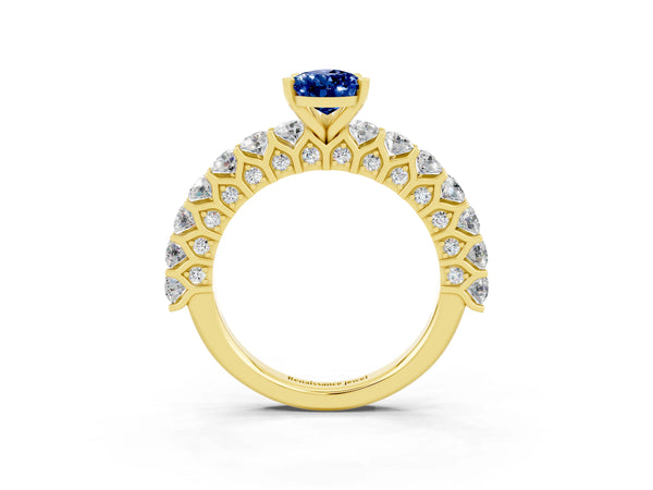 Yellow gold Pear Cut Blue Sapphire Solitaire Ring with Shared Prong Pavé Band and Four-Prong Setting