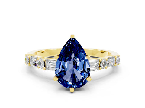 Yellow gold Pear Cut Blue Sapphire Solitaire with Side Baguettes and Channel Set Band