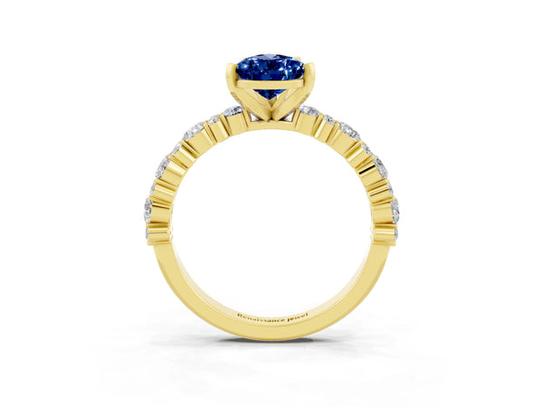 Yellow gold Pear Cut Blue Sapphire Side Stone Solitaire Ring with Round  and Four-Prong Setting