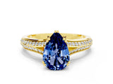 Yellow gold Pear Cut Blue Sapphire Split Shank Engagement Ring with Pavé Band