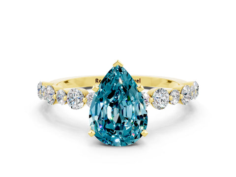 Yellow gold Pear Cut Blue Topaz Prong Set Engagement Ring with Pavé Band