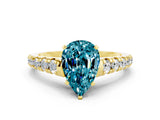 Yellow gold Pear Cut Blue Topaz Solitaire Ring with Cathedral Setting and Pavé Band