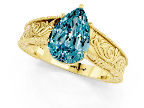 Yellow gold Pear Cut Blue Topaz Solitaire Ring with Engraved Band and Four-Prong Setting_1