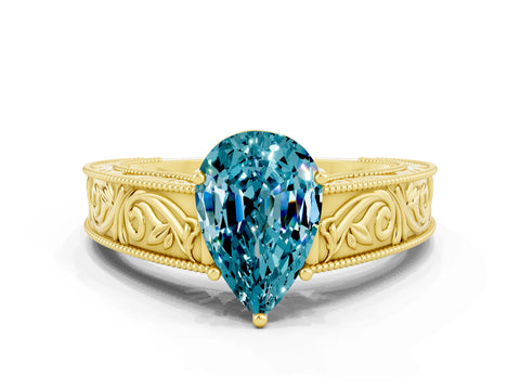 Yellow gold Pear Cut Blue Topaz Solitaire Ring with Engraved Band and Four-Prong Setting