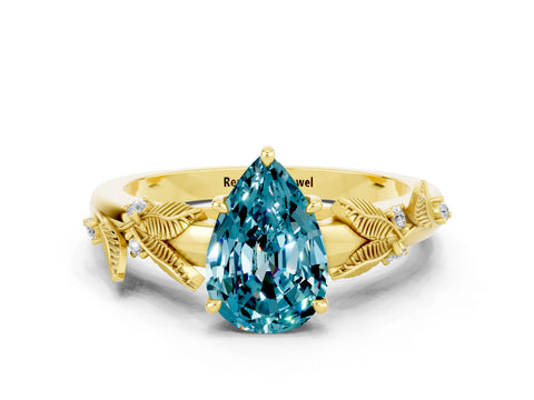 Yellow gold Pear Cut Blue Topaz Solitaire Ring with Leaf Motif Band and Four-Prong Setting