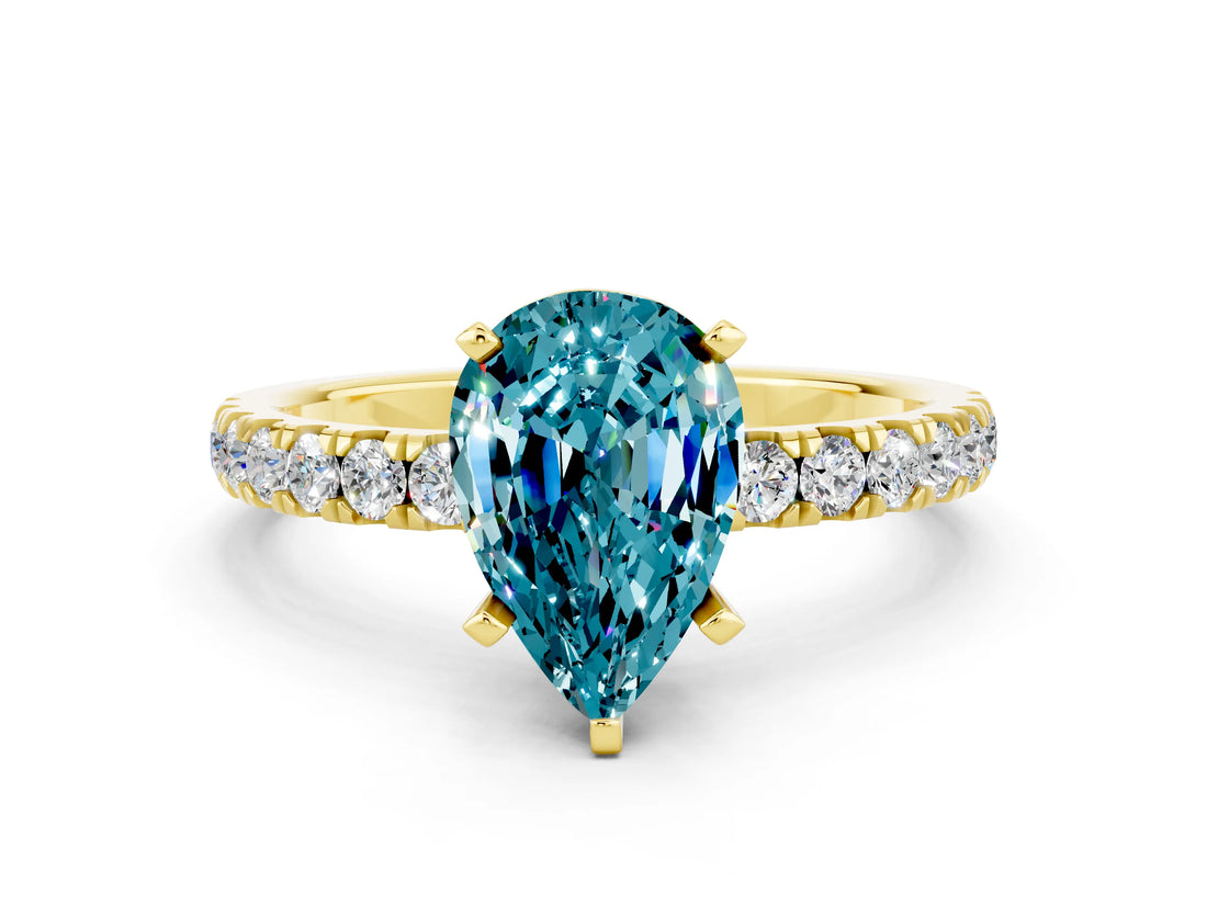 Yellow gold Pear Cut Blue Topaz Solitaire Ring with Pavé Accents and Four-Prong Setting
