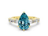 Yellow gold Pear Cut Blue Topaz Solitaire with Side Baguettes and Channel Set Band