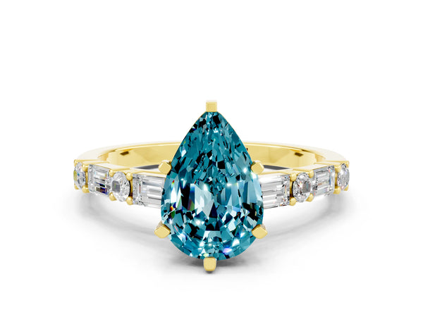 Yellow gold Pear Cut Blue Topaz Solitaire with Side Baguettes and Channel Set Band
